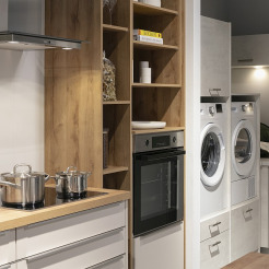 Pino-Küche mit Waschmaschine und Trockner im Seitenbereich - durch Schiebetür von der Küche abgetrennt