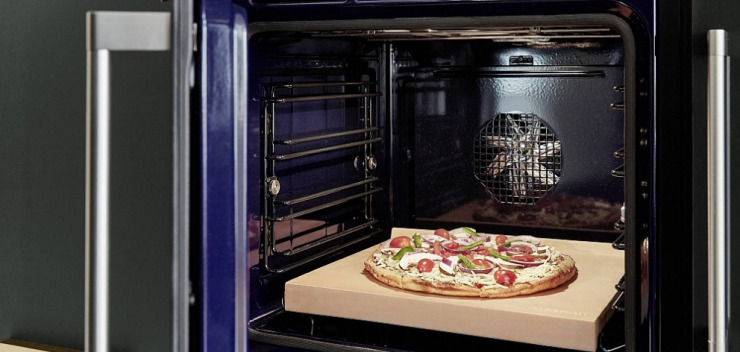 offener Gaggenau-Ofen mit Pizzastein und fertiger Pizza drauf